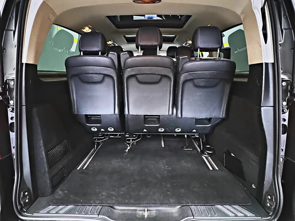 The Mercedes-Benz V-Class load bay with the rear row removed, showing the luggage space available on an airport run